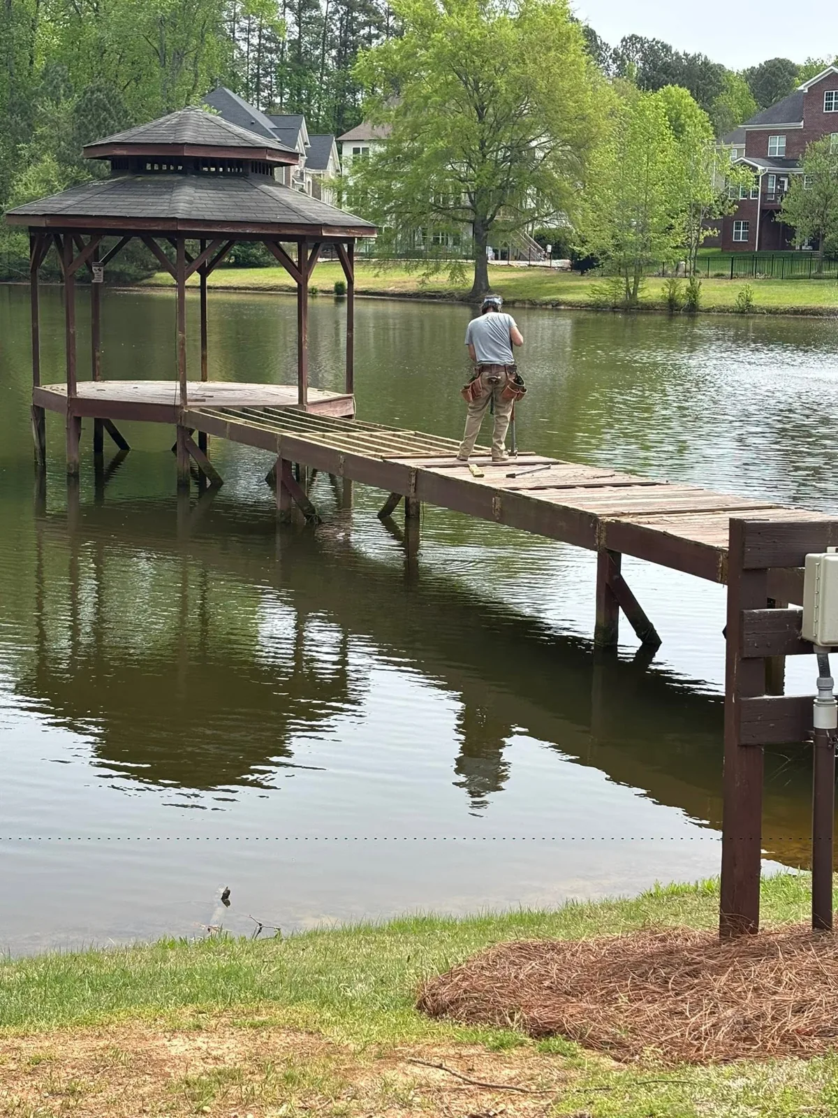 Wooden lake pier and covered dock gazebo